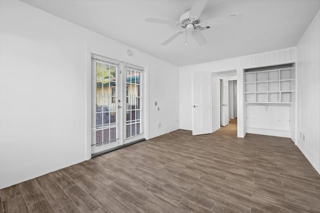 unfurnished bedroom featuring ceiling fan, dark hardwood / wood-style flooring, access to outside, and french doors