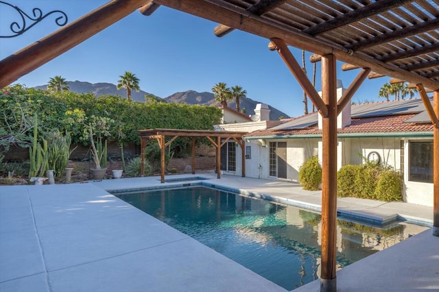 view of swimming pool featuring a pergola, a mountain view, and a patio