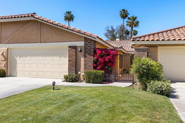 ranch-style home featuring a garage and a front lawn