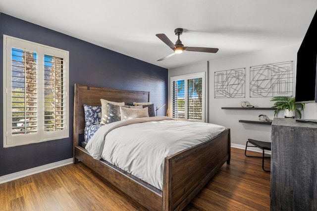 bedroom featuring dark hardwood / wood-style floors, ceiling fan, and multiple windows