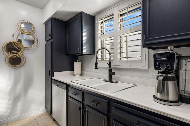 kitchen featuring sink, light tile patterned floors, and stainless steel dishwasher