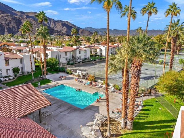 view of pool with a mountain view, a patio area, and a yard