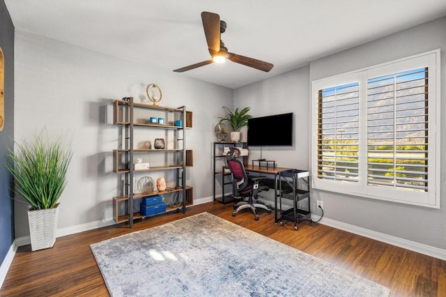 office with dark hardwood / wood-style flooring, ceiling fan, and a healthy amount of sunlight