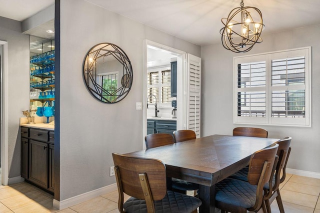 tiled dining room with a chandelier