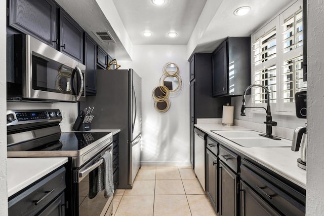 kitchen featuring sink, light tile patterned floors, and stainless steel appliances