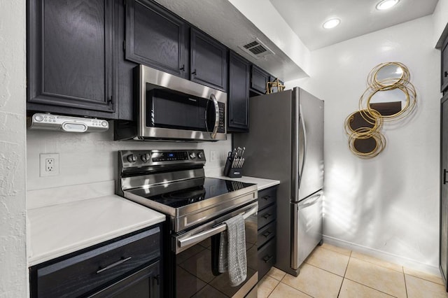 kitchen featuring light tile patterned floors and appliances with stainless steel finishes