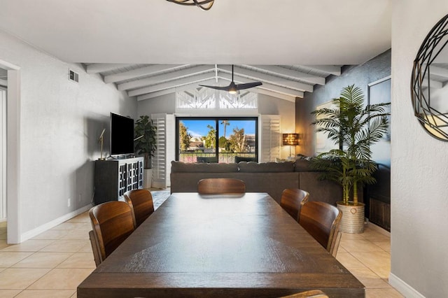 dining area featuring light tile patterned floors and lofted ceiling with beams