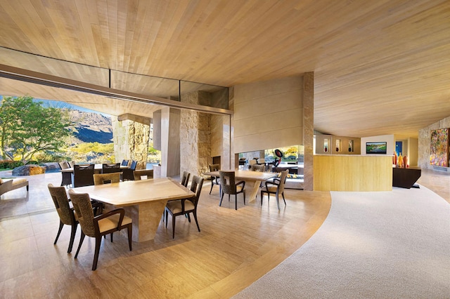 dining room with a healthy amount of sunlight and wooden ceiling