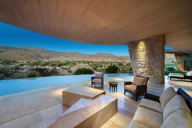 view of patio with a mountain view and an outdoor hangout area