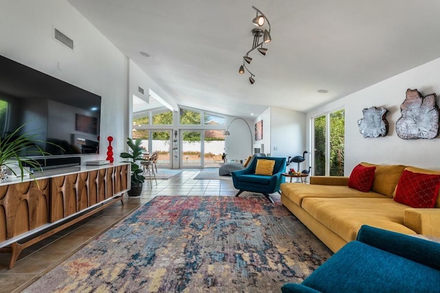 living room with tile patterned floors, vaulted ceiling with beams, and a wealth of natural light