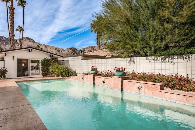 view of swimming pool with a mountain view