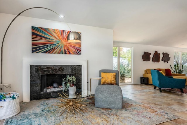 sitting room featuring plenty of natural light and a tiled fireplace