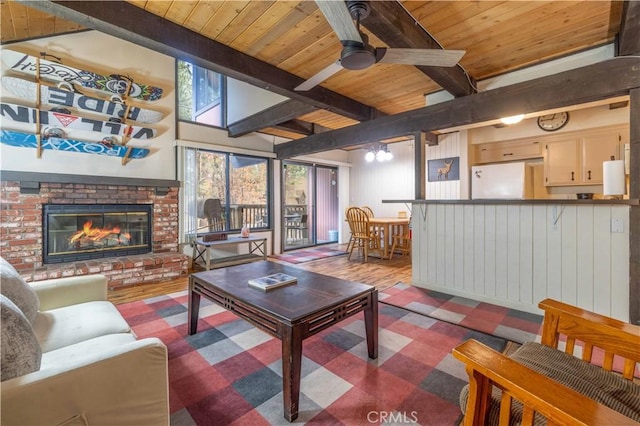 living room featuring ceiling fan, beam ceiling, light wood-type flooring, and wood ceiling