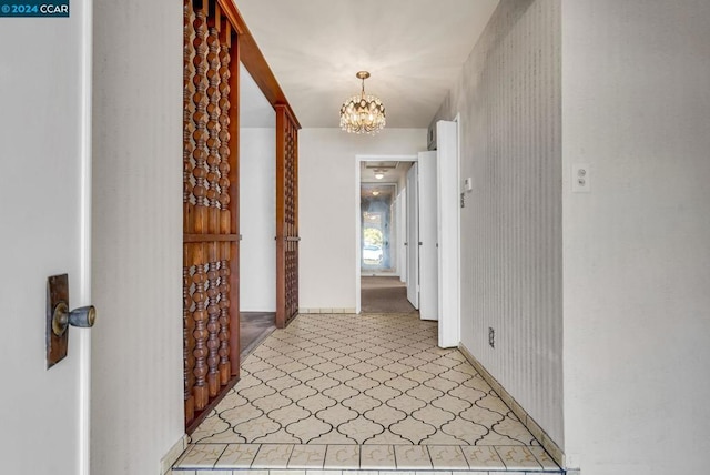 hall featuring a notable chandelier