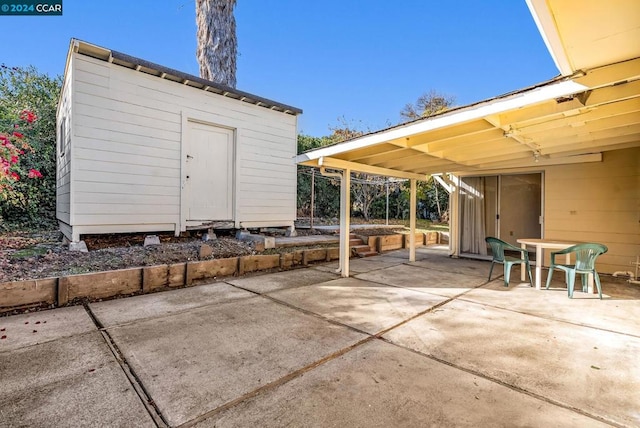 view of patio with a storage unit