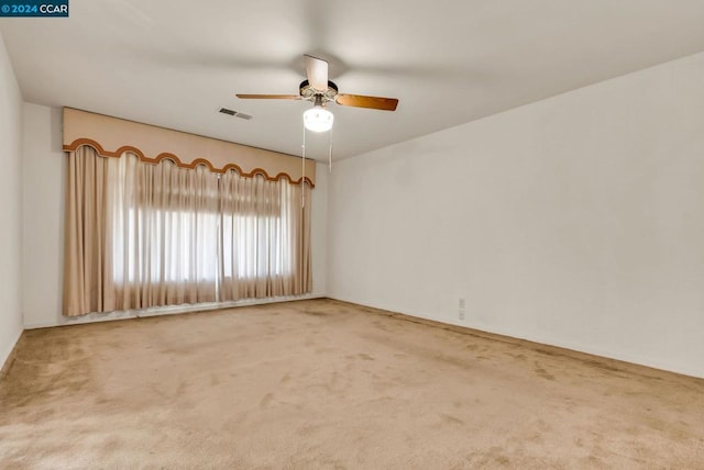 empty room featuring ceiling fan and carpet floors