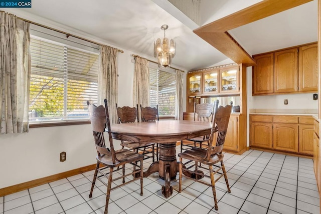 dining space featuring light tile patterned floors, an inviting chandelier, and plenty of natural light