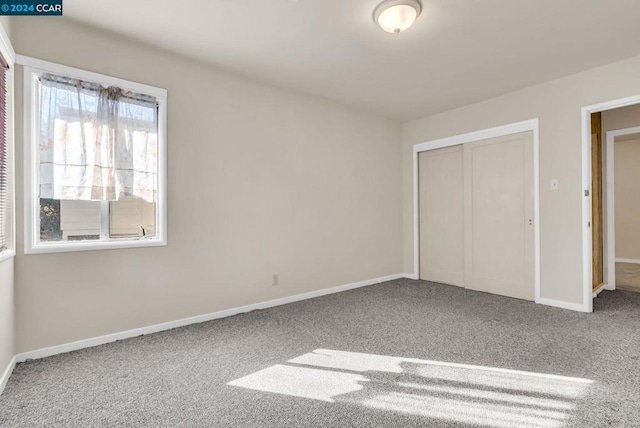 unfurnished bedroom with carpet and a closet