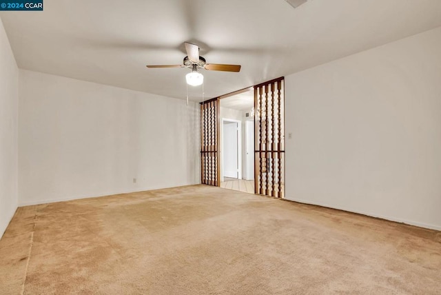 carpeted empty room featuring ceiling fan