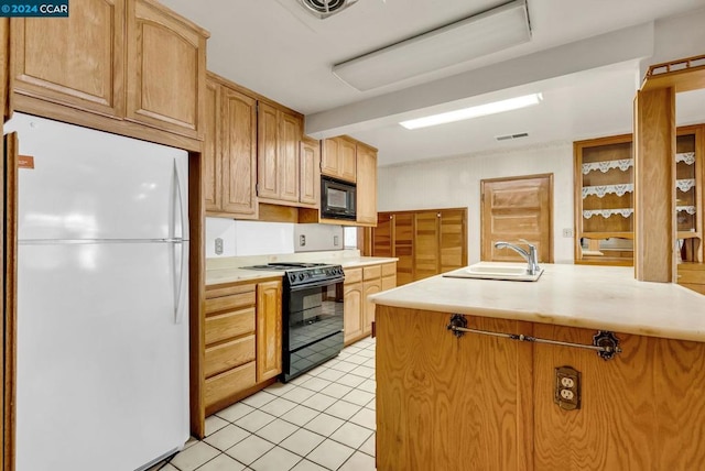 kitchen with sink, light tile patterned flooring, and black appliances