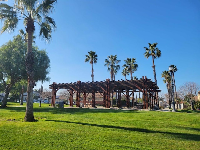 view of home's community featuring a lawn and a pergola