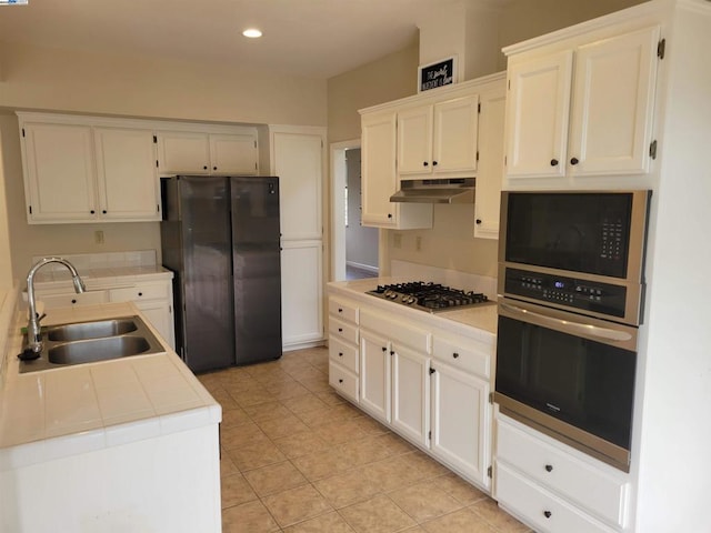 kitchen with sink, stainless steel appliances, and white cabinetry