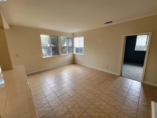 spare room featuring crown molding and light tile patterned flooring