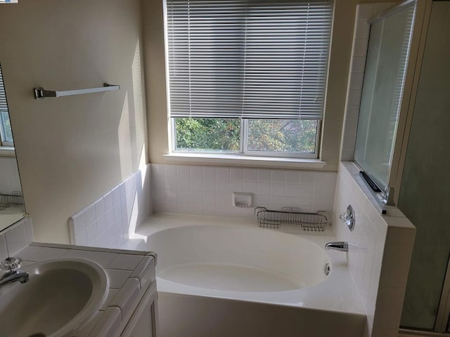 bathroom with independent shower and bath and sink