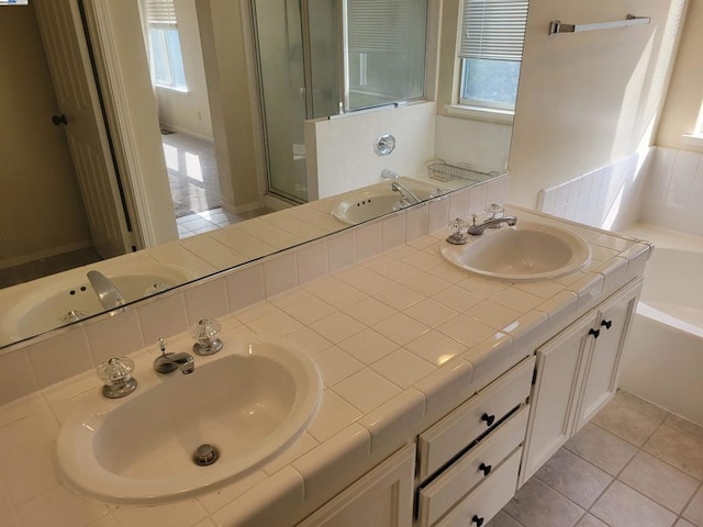 bathroom featuring shower with separate bathtub, tile patterned floors, and vanity