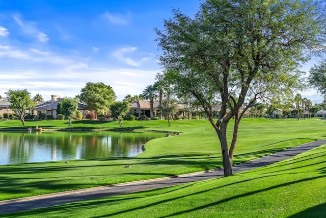 view of home's community featuring a water view and a yard