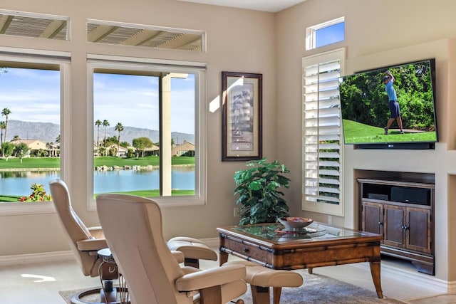 office space with a wealth of natural light and a water and mountain view