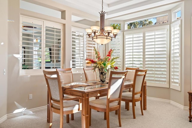 carpeted dining space featuring an inviting chandelier