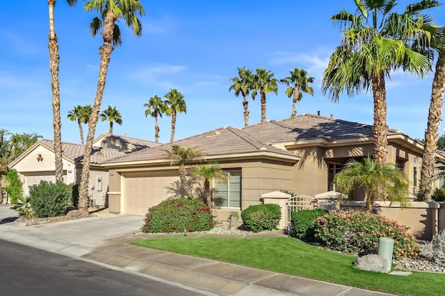 view of front of house featuring a front yard and a garage