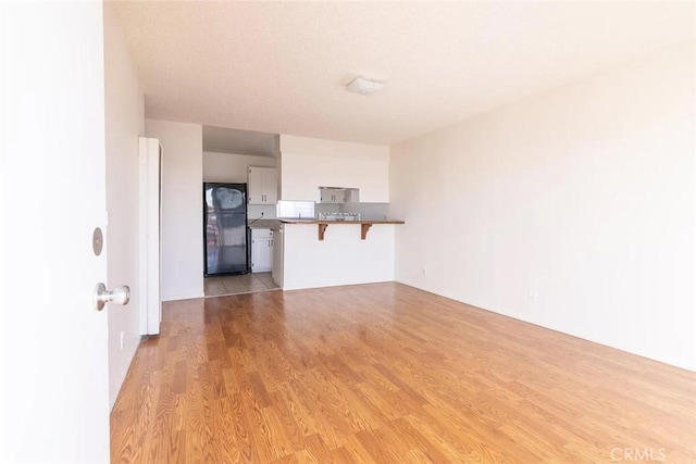 unfurnished living room with light wood-type flooring