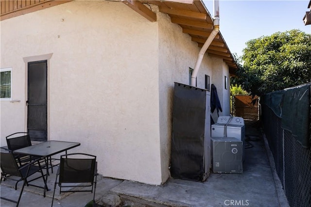 view of side of home featuring washing machine and dryer