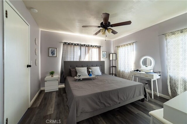 bedroom featuring dark hardwood / wood-style flooring and ceiling fan