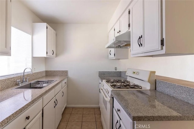 kitchen featuring white gas stove, white cabinetry, sink, and light tile patterned floors