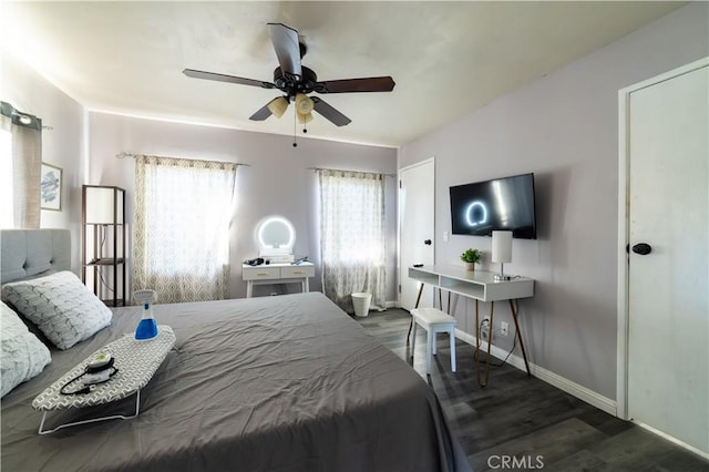 bedroom with dark hardwood / wood-style flooring and ceiling fan