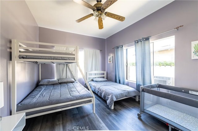 bedroom featuring ceiling fan, cooling unit, and dark hardwood / wood-style floors