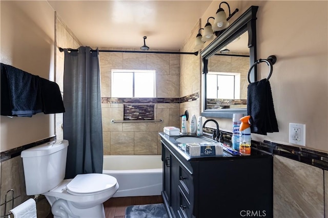 full bathroom featuring toilet, vanity, and shower / tub combo with curtain