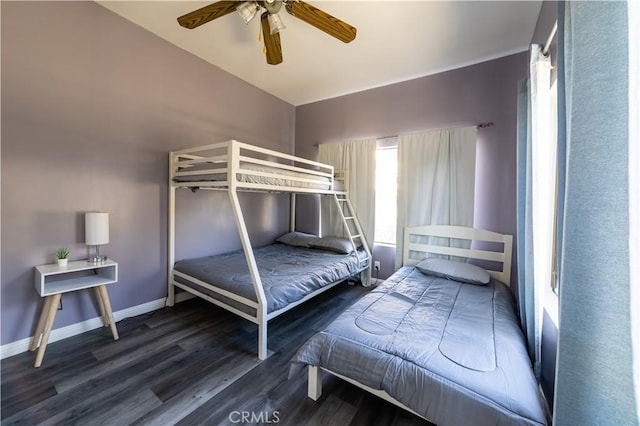 bedroom with ceiling fan and dark wood-type flooring