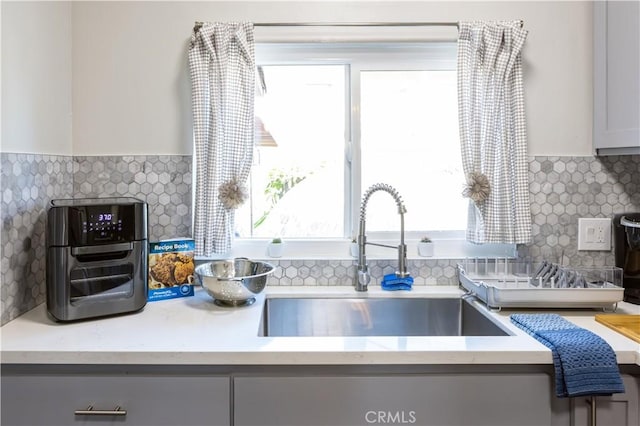 kitchen featuring backsplash and sink