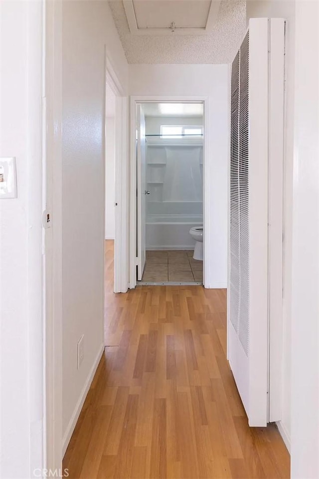 hall with light hardwood / wood-style floors