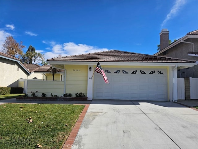 view of front of home with a front yard and a garage