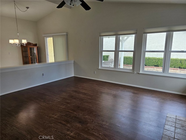 unfurnished room featuring dark hardwood / wood-style floors, lofted ceiling, and ceiling fan with notable chandelier