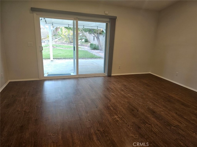 spare room featuring dark wood-type flooring