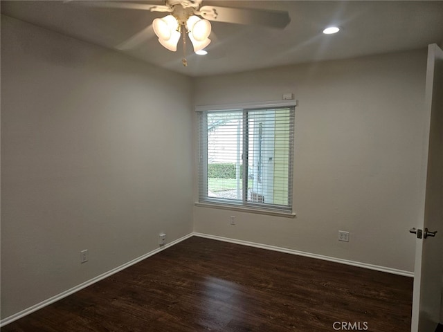 empty room featuring ceiling fan and dark hardwood / wood-style floors