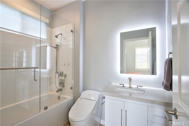 full bathroom with shower / bath combination with glass door, vanity, and toilet