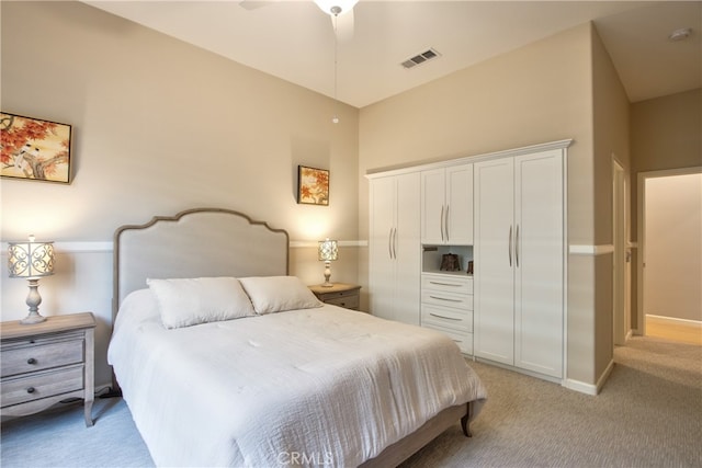 carpeted bedroom featuring ceiling fan, vaulted ceiling, and a closet