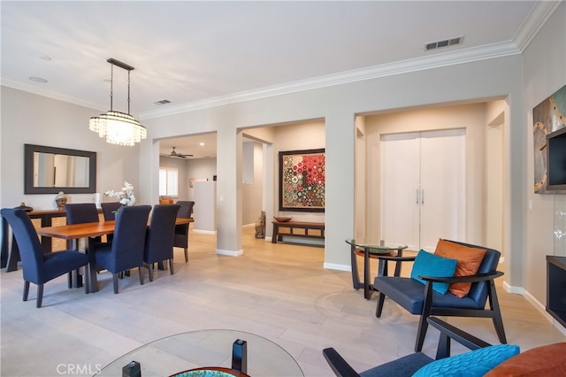 dining space featuring ceiling fan with notable chandelier, light wood-type flooring, and ornamental molding